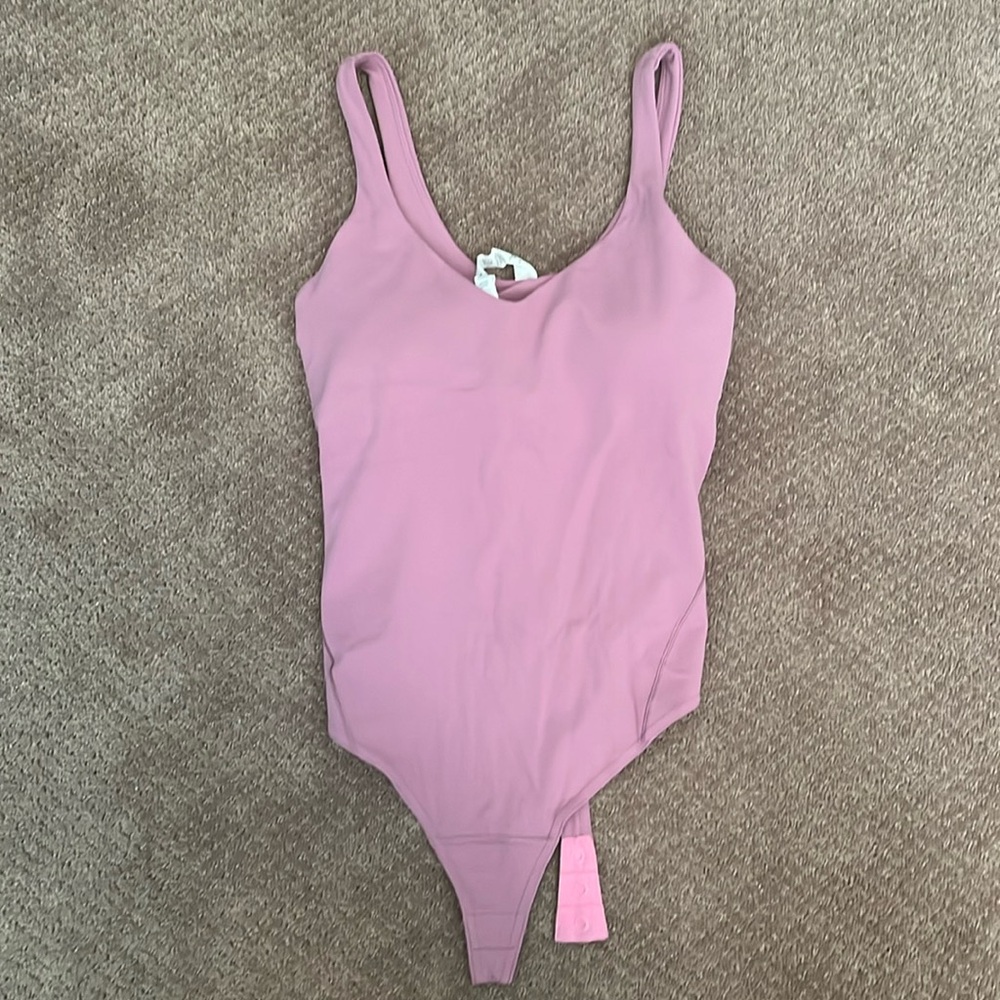 Brand new body suit, removed the tags but never wore it